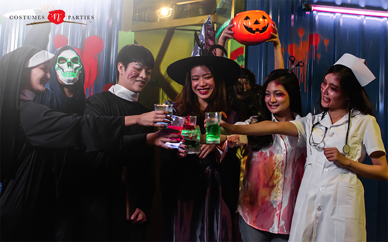 A group of friends raising a toast at a halloween party